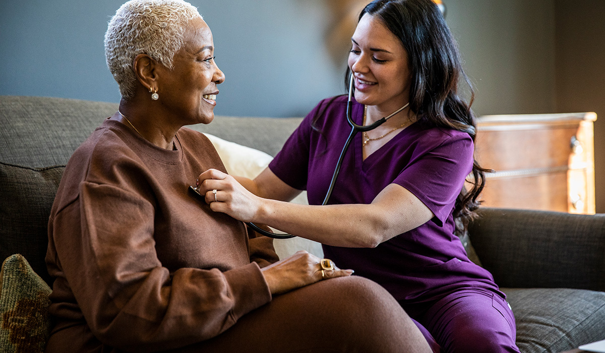 A nurse listens to a patient's heart. Gut health is connected to cardiovascular health.