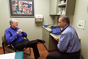 Larry Gassner, MD, talks to a member of his MDVIP-affiliated practice