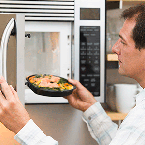 Man opening microwave oven door