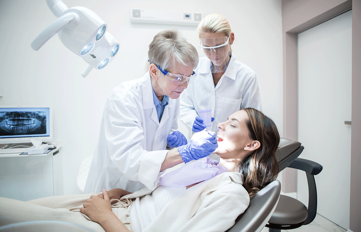 A dentist cleaning teeth