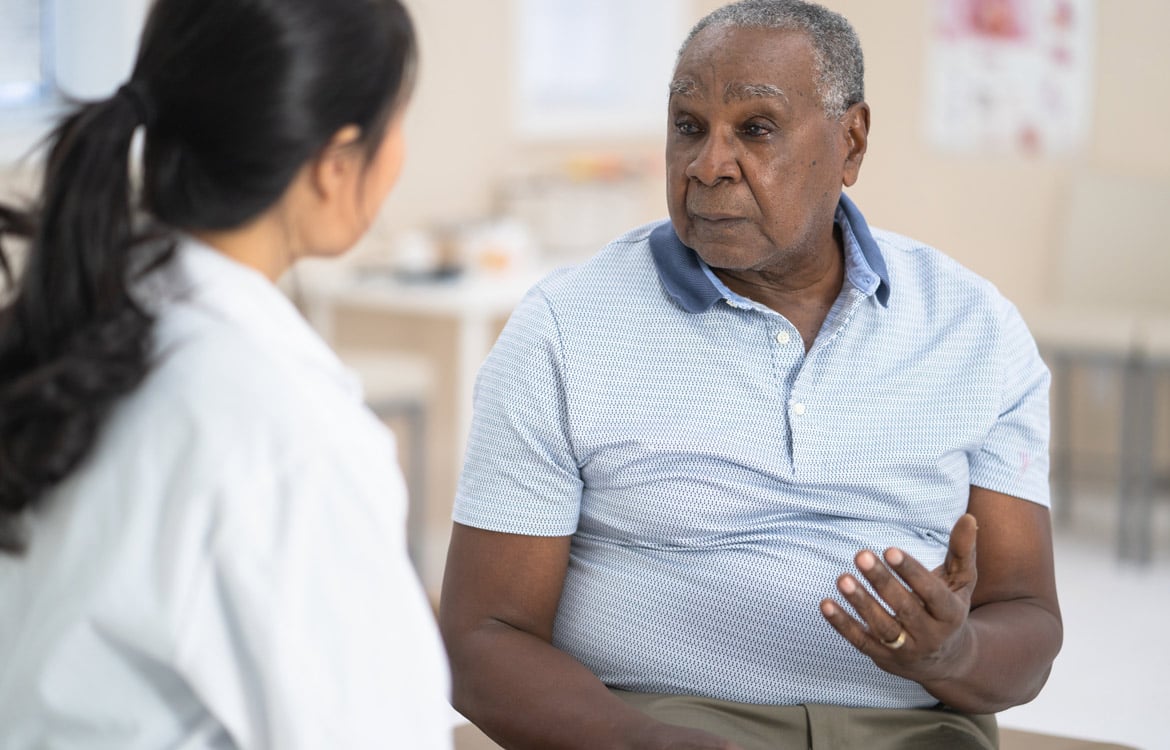 Older man talking to his doctor in a doctor's office