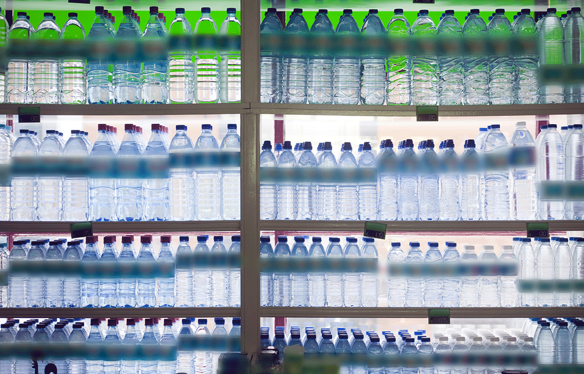 Supermarket shelves with bottles of water