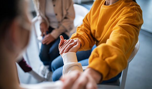 Two people holding hands in a waiting room