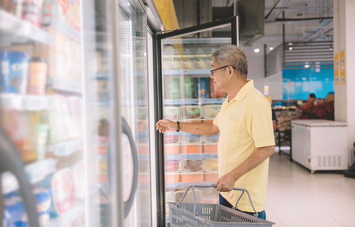 shopper opening fridge door in grocery store
