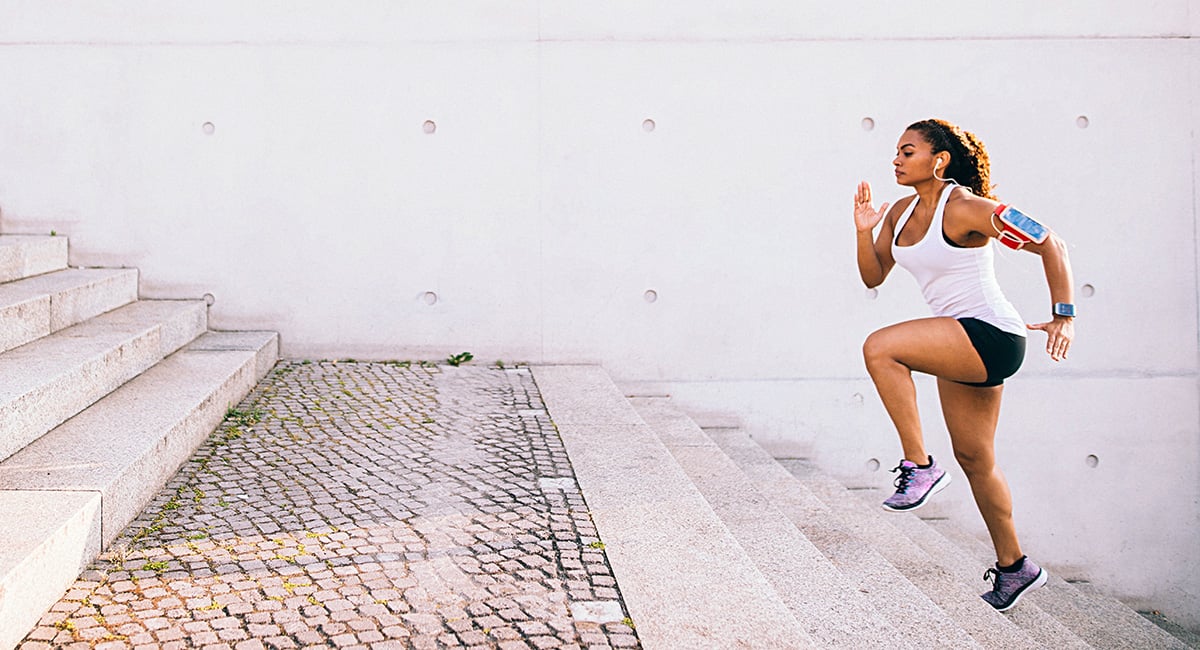 A woman running up stairs. Exercise can help stress.