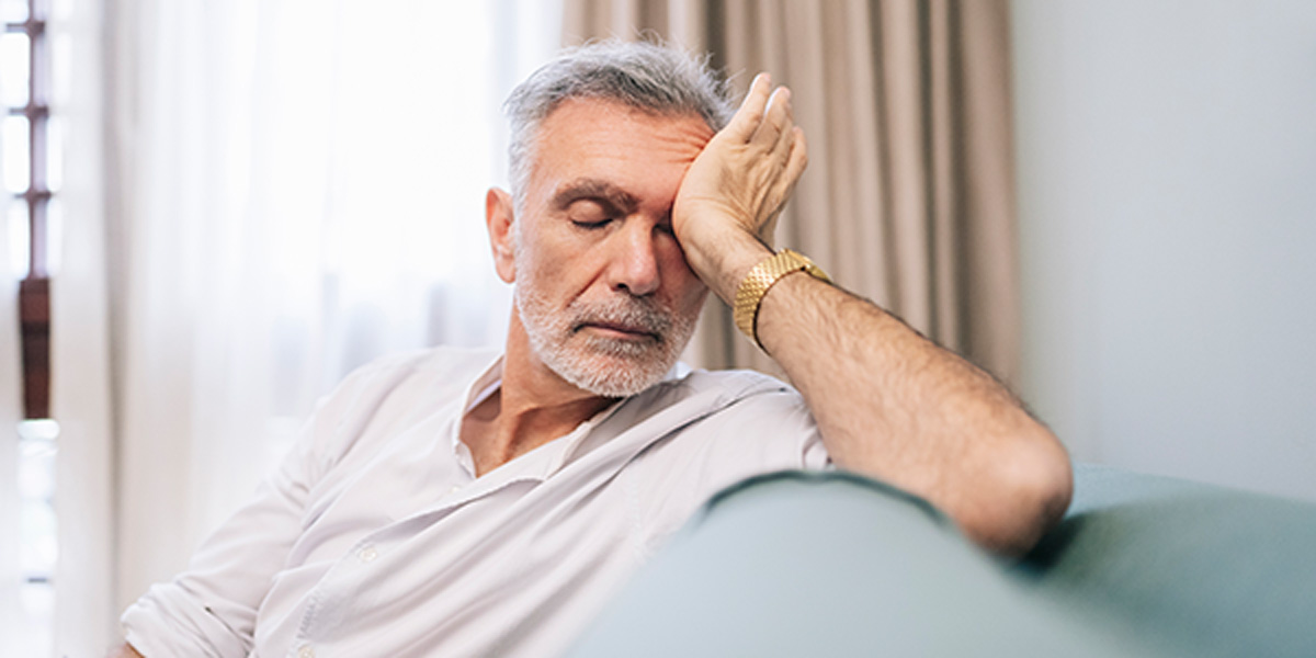 Older man suffering from fatigue. Fatigue isn't a normal part of aging and can be caused by medications.