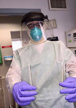 Scott Rex, MD, suited up to test patients for COVID-19.