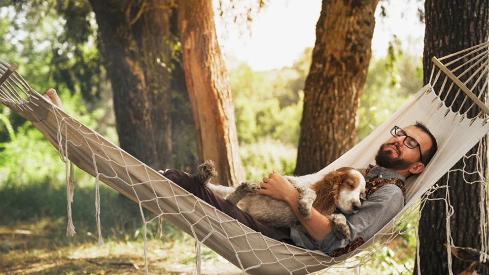 man relaxing on hammock