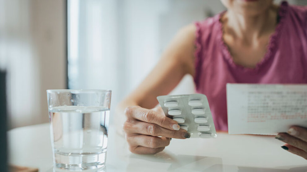 Woman looking at medication and instructions