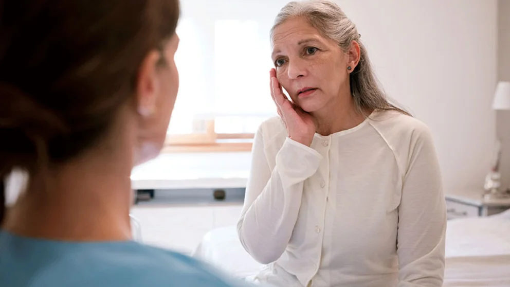 Older woman talking to doctor