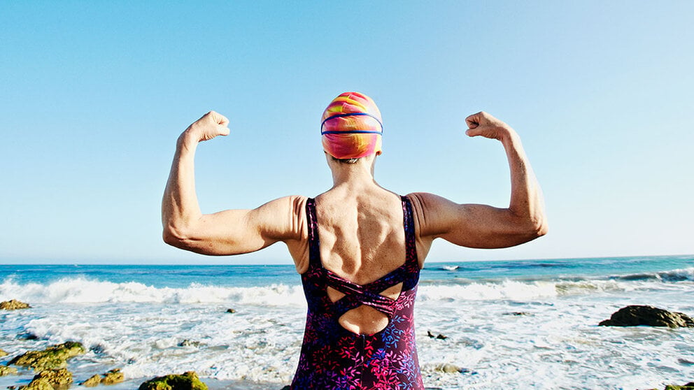 Older woman exercising at beach