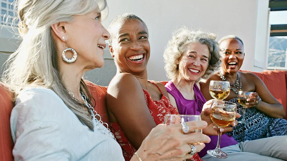 4 women drinking wine