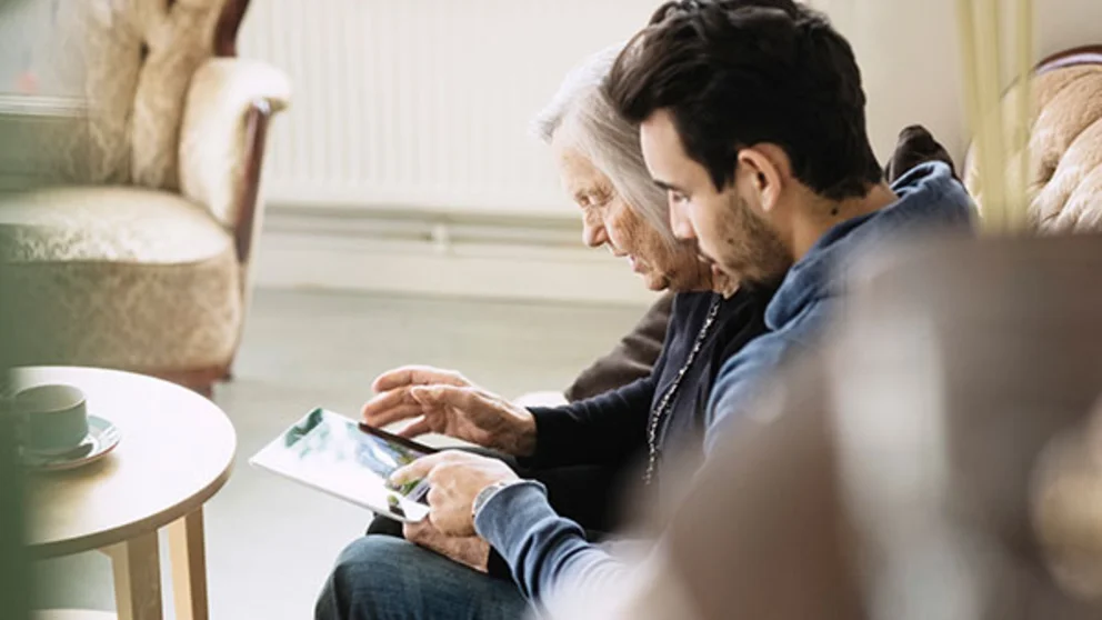 A man talks to his elderly mother who has dementia