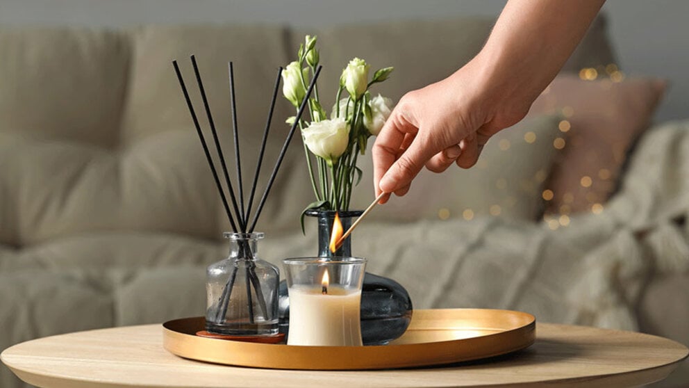 Reeds, oil, candle, flower in vase