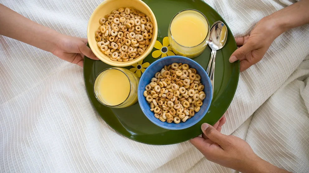 Two Bowls of Breakfast Cereal and Orange Juice