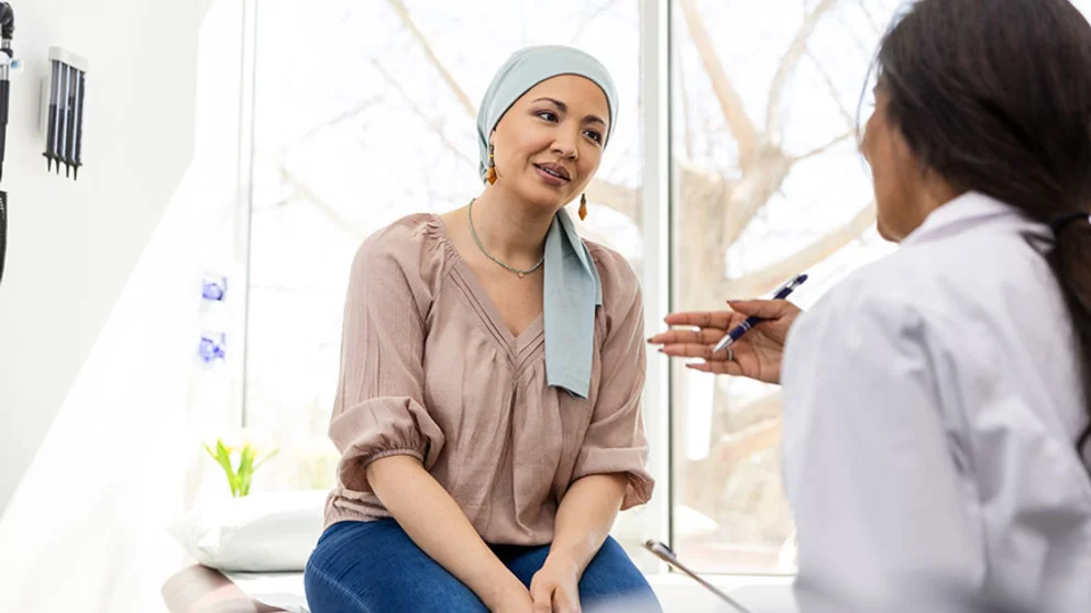 Female cancer patient talking to female physician