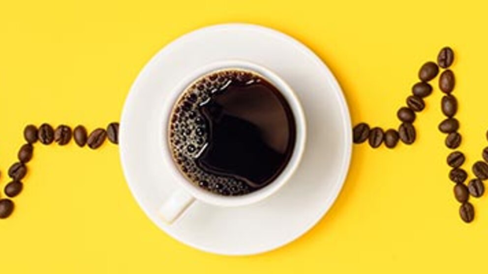 An illustration of a coffee cup, coffee beans and heart rate.