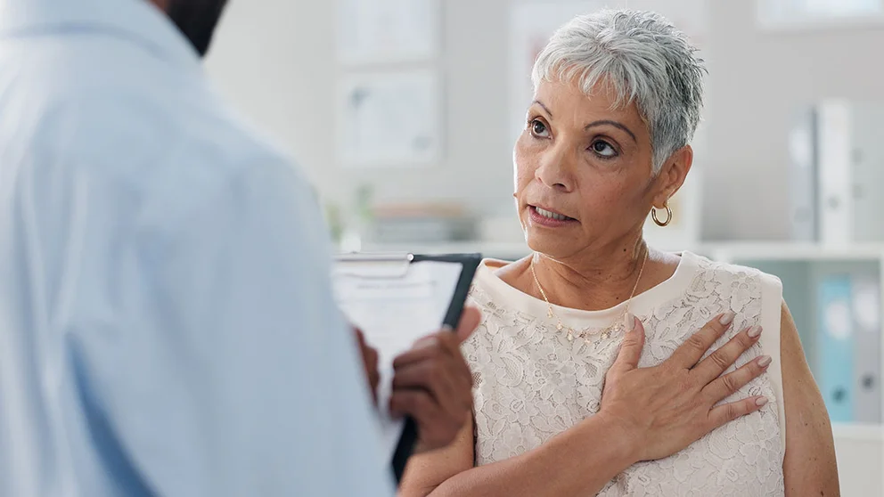 Female patient talking to doctor about heart
