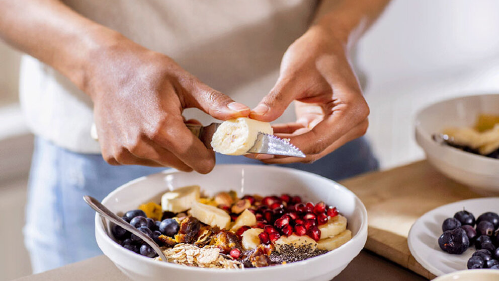 Man preparing healthy snack bowl