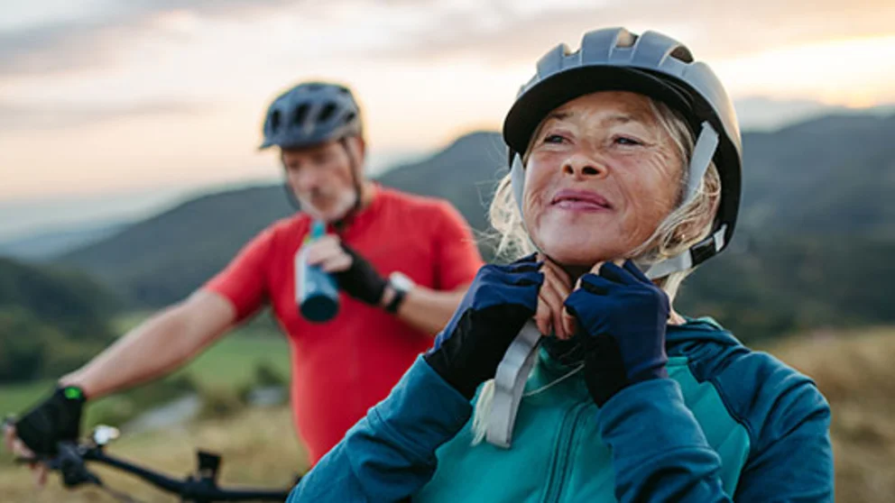 Woman and man mountain biking.