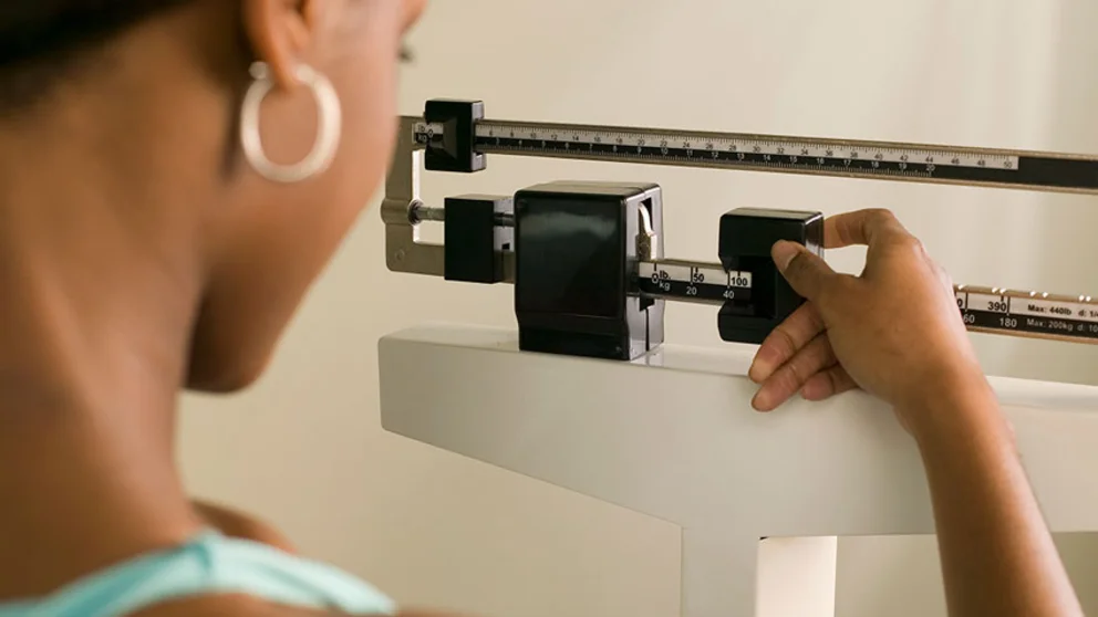 Woman on clinical scale