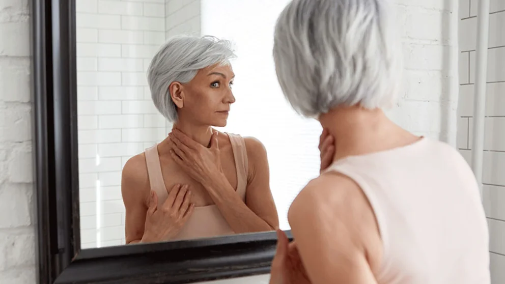 A women looking at herself in the mirror