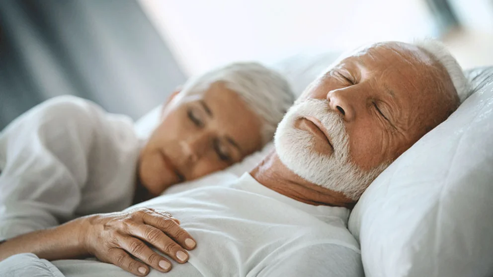 A couple sleeping in bed
