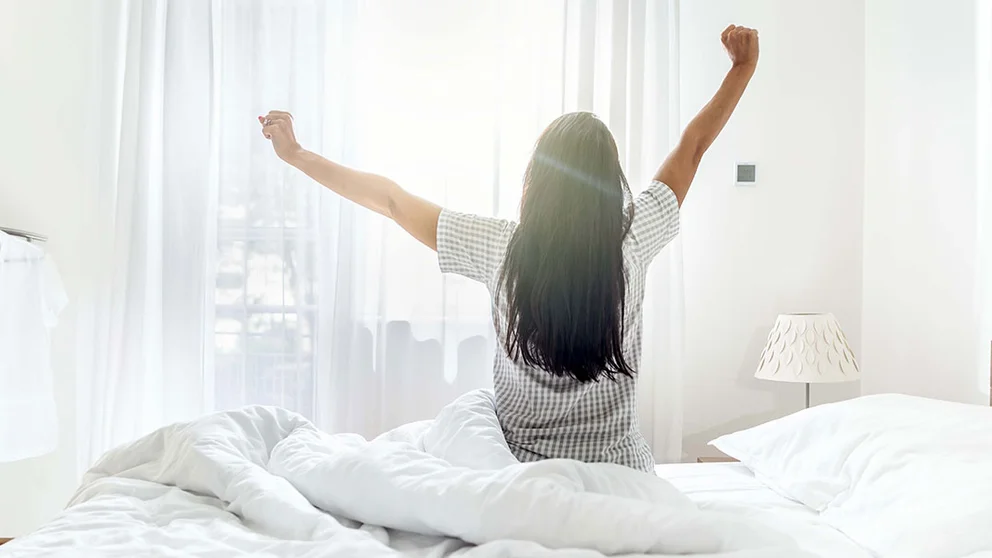 woman waking from good night's sleep