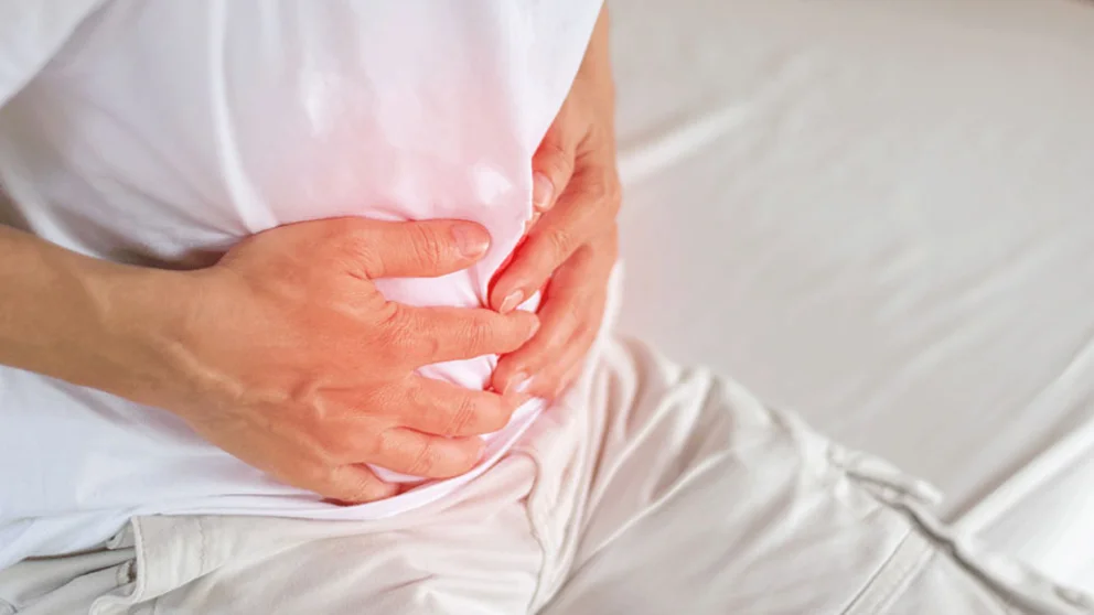 Man holding his stomach in pain