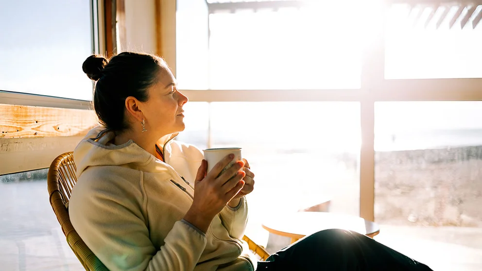 Woman relaxing while drinking a cup of green tea