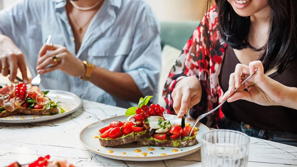 Two people eating a healthy meal.