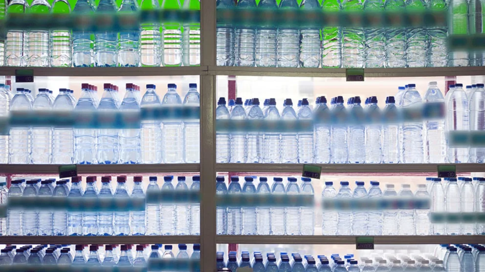 Supermarket shelves with bottles of water