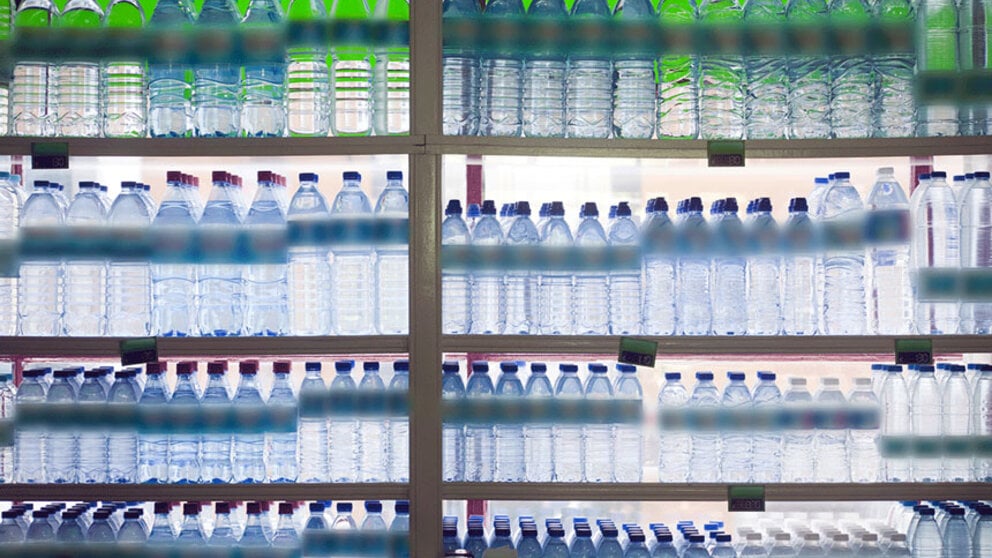 Supermarket shelves with bottles of water