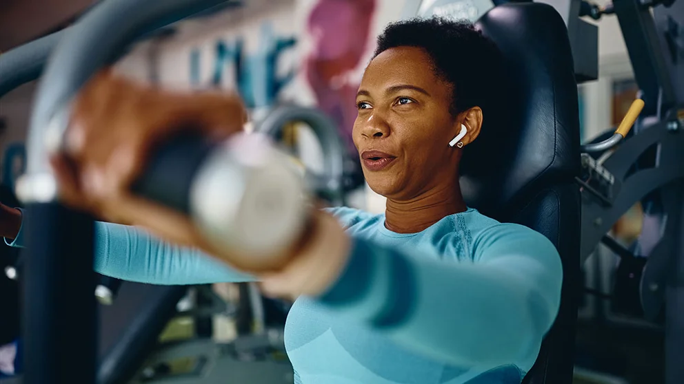 Woman using chest press machine