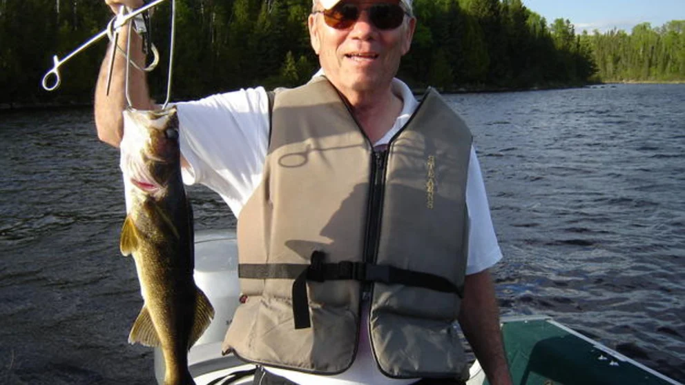 John Back Holding Up His Fishing Catch