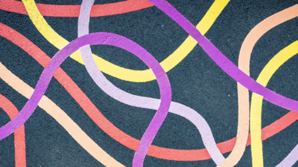 Abstract network of colorful flowing lines on a dark background, symbolizing movement, coordination, and overall wellness.