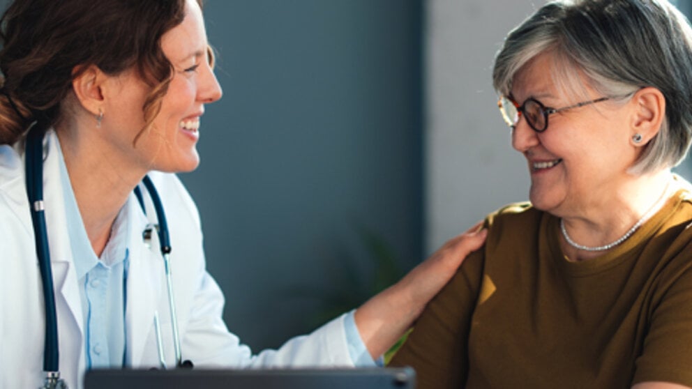 Doctor speaking with a patient during an office visit.