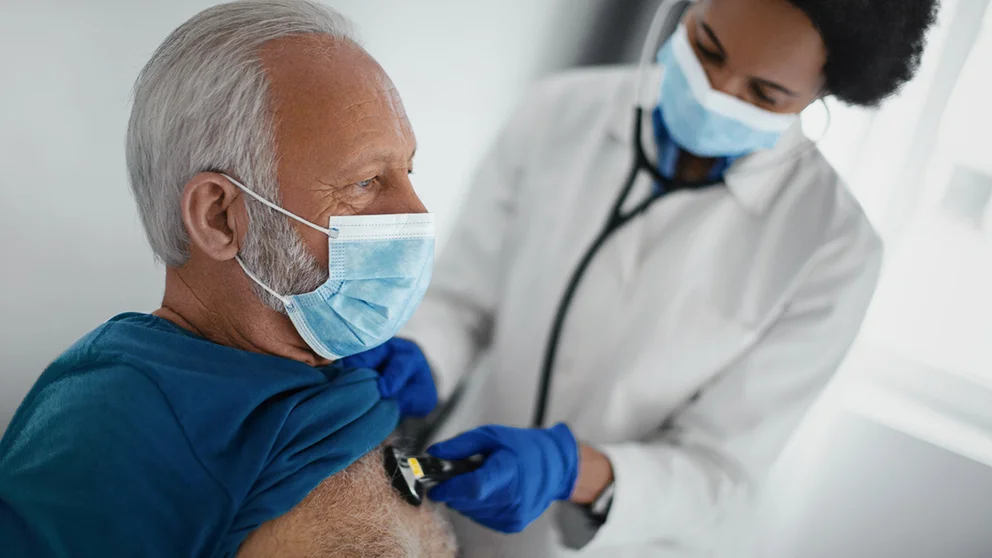 Elderly man having his heart checked by a doctor
