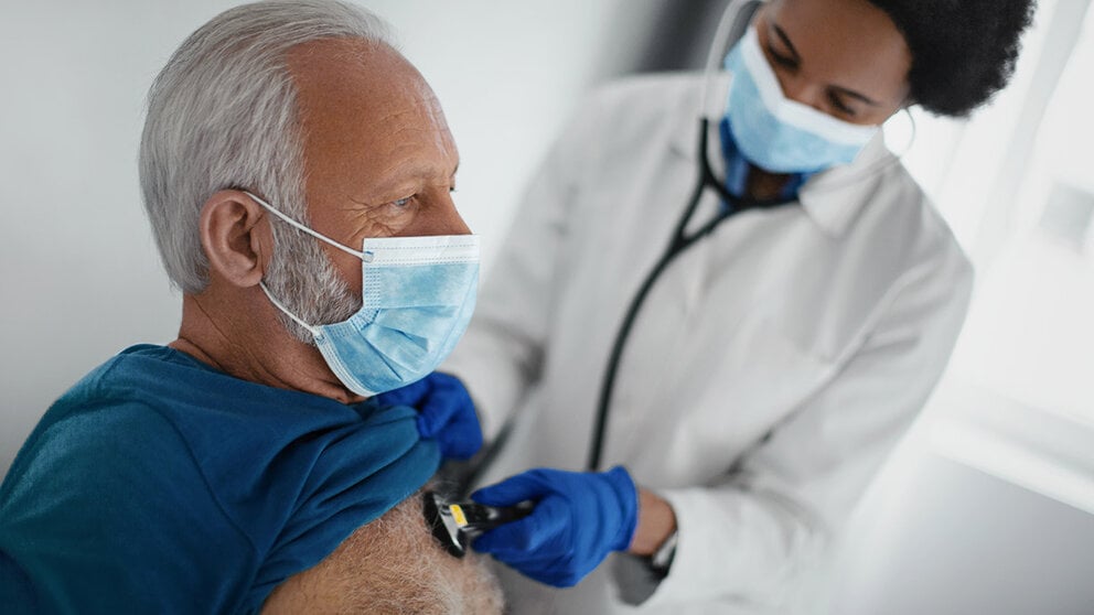 Elderly man having his heart checked by a doctor