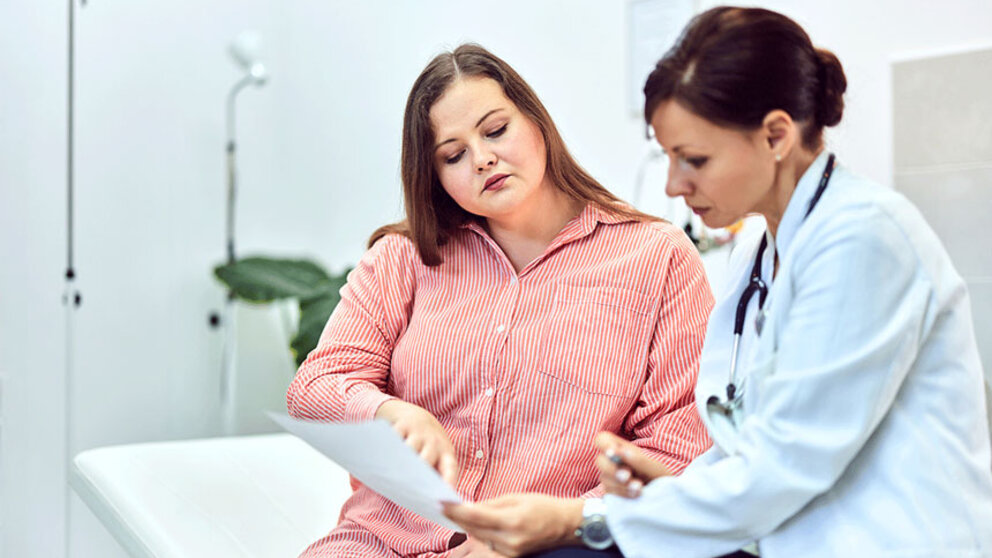 Overweight woman talking to doctor about lab results