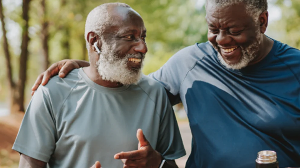 Two older adults enjoying an outdoor walk together, highlighting exercise, social connection, and healthy lifestyle habits that support metabolic health.