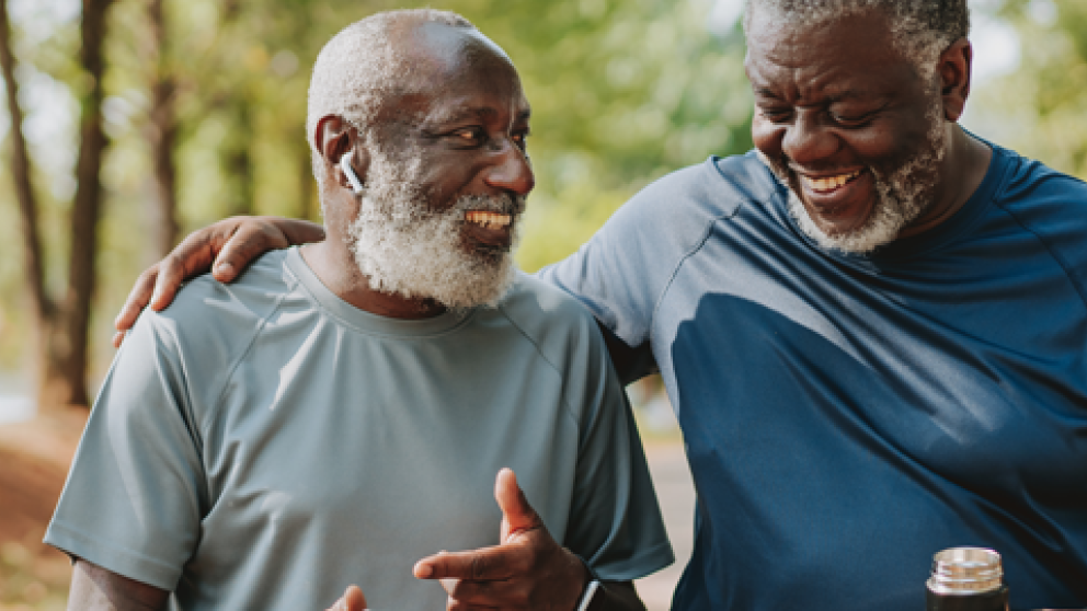 Two older adults enjoying an outdoor walk together, highlighting exercise, social connection, and healthy lifestyle habits that support metabolic health.