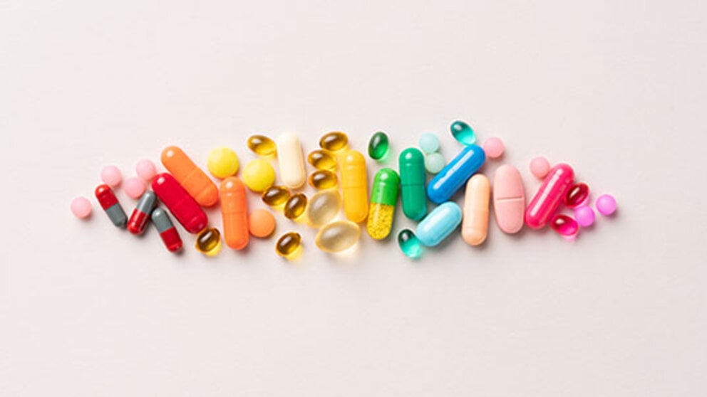 Colorful vitamins and supplements against a light background.