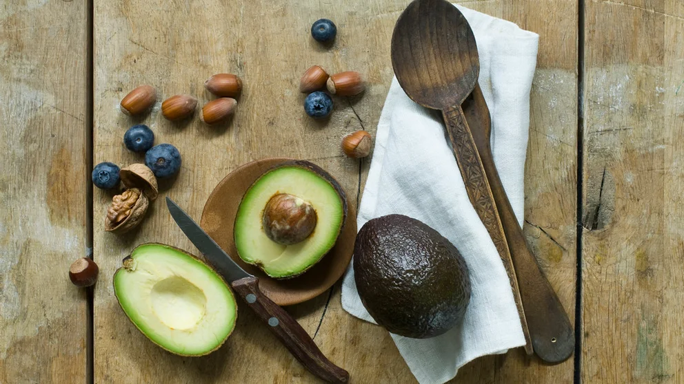 opened avocado and blueberries on tabletop