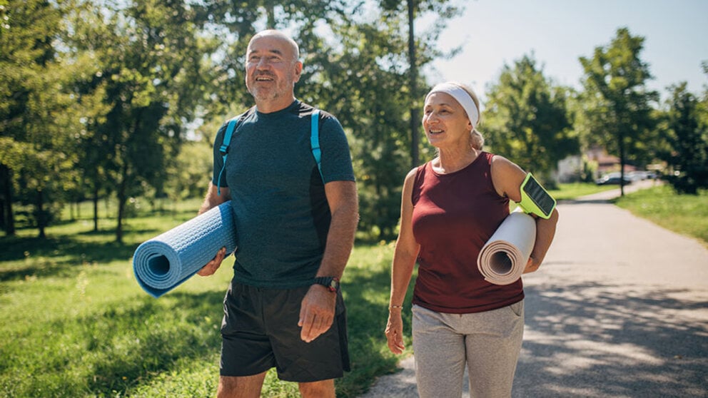 Middle age couple going to outdoor yoga
