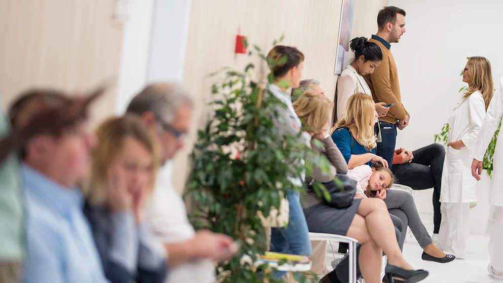patients waiting in a crowded waiting room