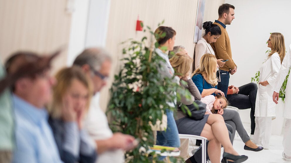 patients waiting in a crowded waiting room