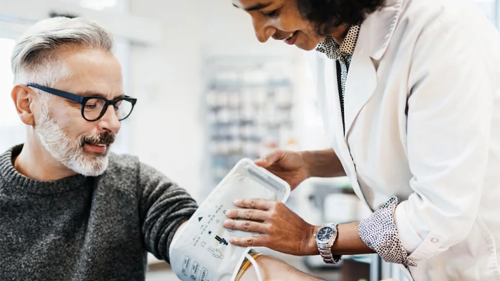 A doctor takes a patient's blood pressure