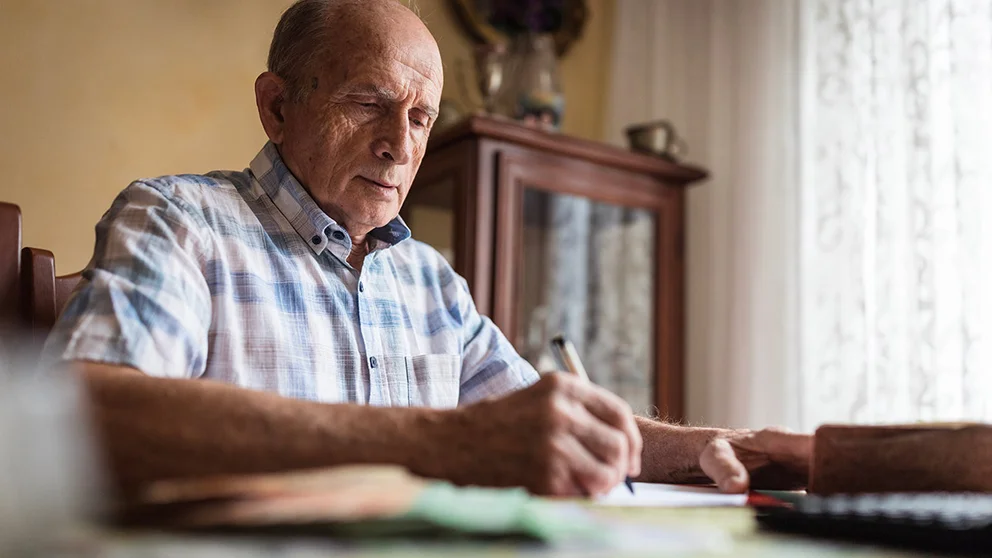Older man filling out papers