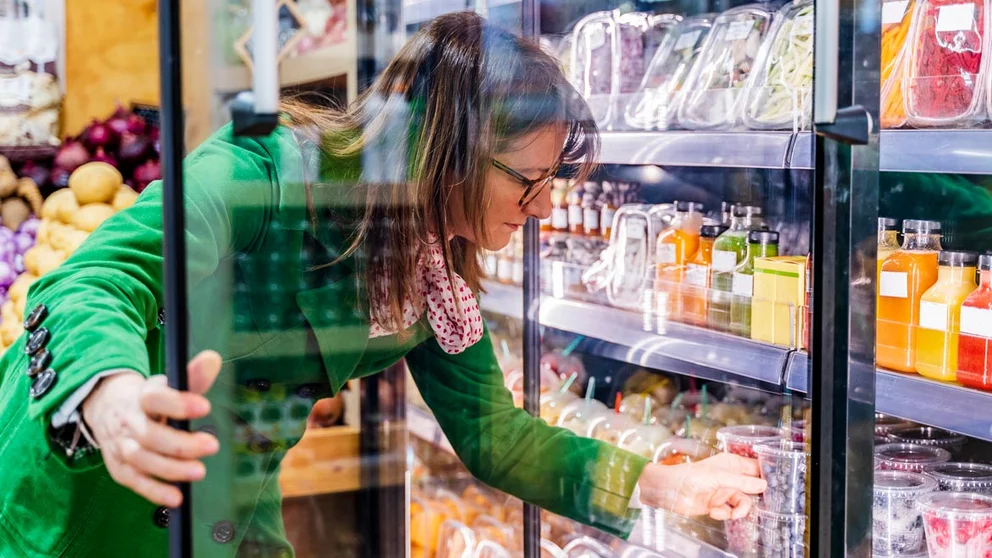 woman looking at fruit options in the grocery store
